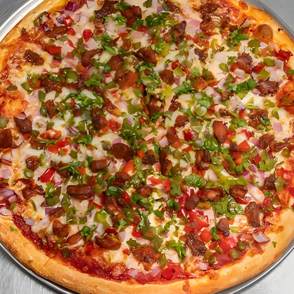 A close-up of a whole Apna Pizza, topped with cheese, red onions, green peppers, and meat.